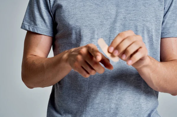 Man with a plaster on his finger injury treatment medicine — Stock Photo, Image