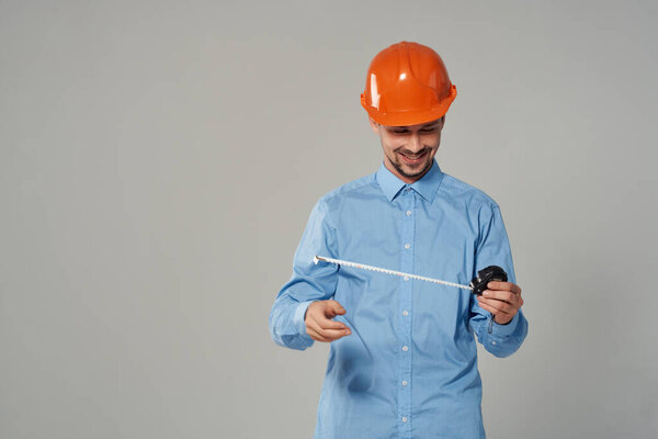 man in orange helmet blueprints builder isolated background