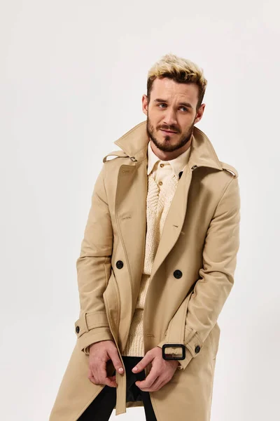 man in coat self confidence fashion modern style light background