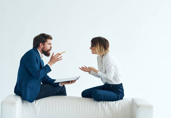 man and woman communication white sofa emotions team documents