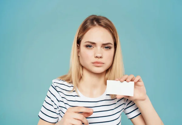 pretty woman with a business card in hand in Studio. High quality photo