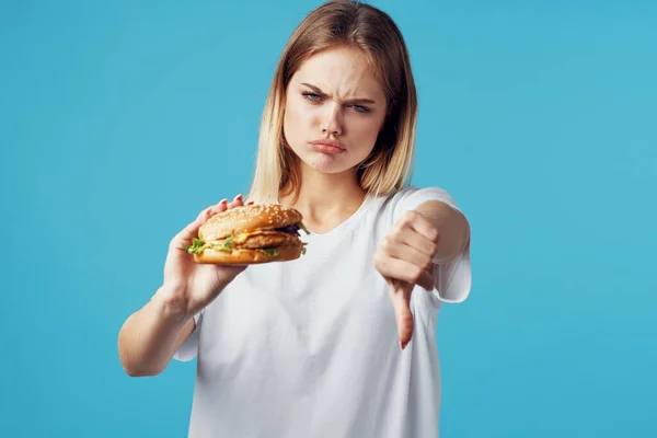 Женщина с гамбургером быстрого питания доставки закуски весело синий фон — стоковое фото