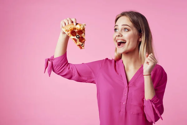 Loira alegre com pizza em suas mãos junk food snack rosa fundo — Fotografia de Stock