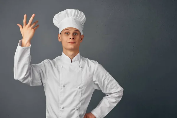 chef with a cap on his head gesturing with his hands work profession