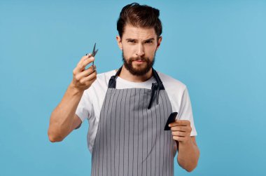 Önlüklü adam güzellik salonu mavi arka plan