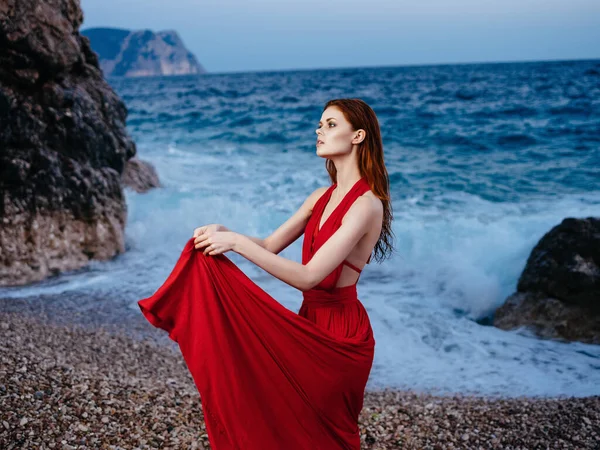 Femme en robe rouge sur la plage océan posant romance de luxe — Photo