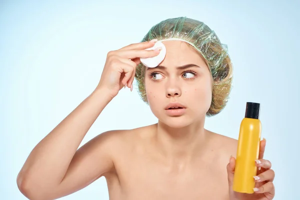 Woman wipes face with lotion naked shoulders skin care cosmetology — Stock Photo, Image