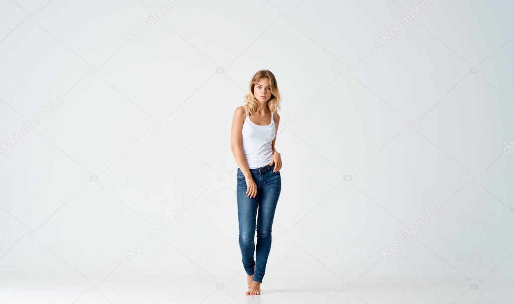 pretty blonde in jeans barefoot posing fashion isolated background