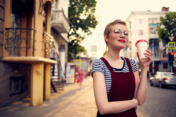 Short haired woman wearing glasses outdoors walk leisure drink cup — Stock Photo, Image