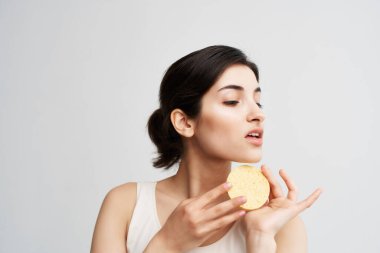 Elinde süngerle esmer, temiz cilt bakımı kozmetik.