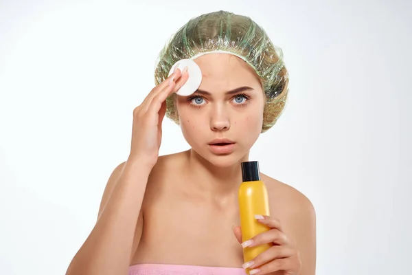 Woman with pink towel nude ringlets cream skin care light background — Stock Photo, Image