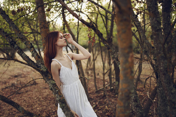 Pretty woman in white dress forest nature walk vacation. High quality photo