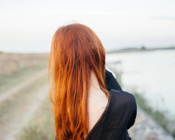 Vacker kvinna svart duk poserar natur landskap promenad — Stockfoto