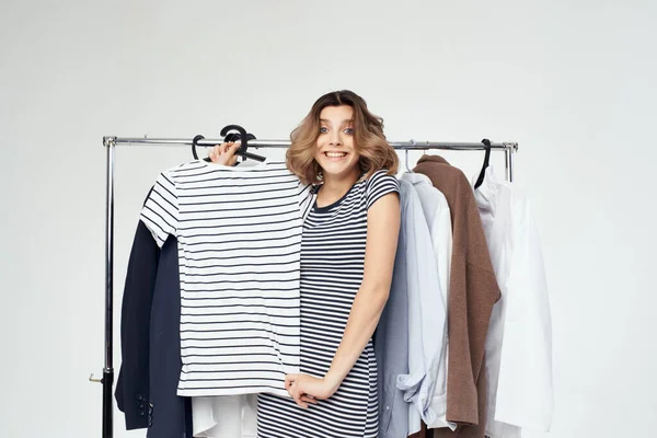 beautiful woman trying on clothes isolated background