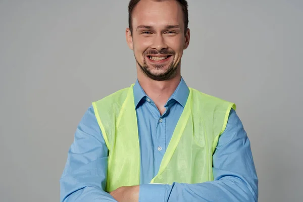 male builder in working form construction work light background