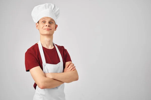 A man in a chefs uniform a frying pan in the hands of a professional cooking — Stock Photo, Image