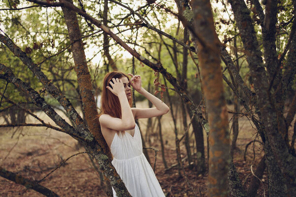 Women outdoors in the forest in white dress posing. High quality photo