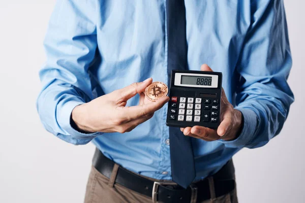 Homem segurando uma calculadora criptomoeda bitcoin investimento em dinheiro virtual — Fotografia de Stock