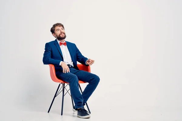 business man in a suit sitting on a chair studio modern style