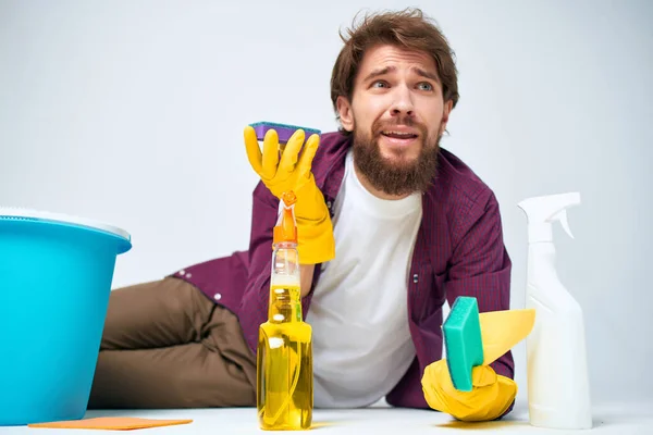 man with detergent cleaning the apartment provision of services