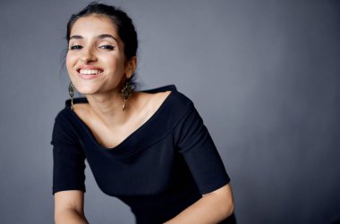 Güzel bir kadın modellik yapıyor. Çekici görünüyor. Süslü gülüyor.