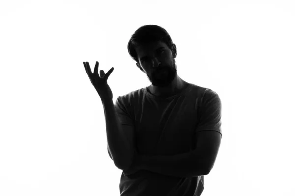 Brodaty mężczyzna w cieniu anonimowy blacha z rękami lekkie tło — Zdjęcie stockowe