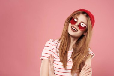 Kırmızı şapkalı neşeli kadın yaz pozu veriyor.