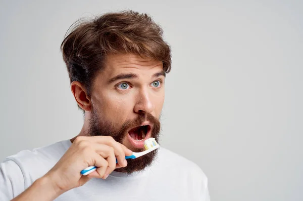 Emocionální muž hygiena zubní pasta ráno izolované pozadí — Stock fotografie