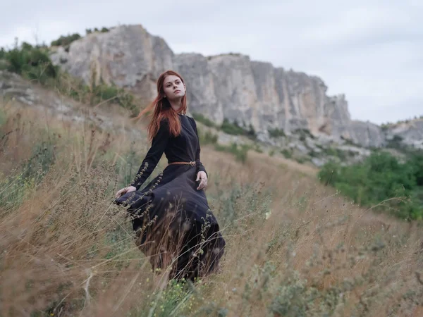 Mulher de vestido preto ao ar livre montanhas andar Estilo de vida liberdade — Fotografia de Stock