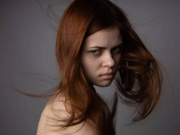 attractive woman red hair naked shoulders posing close-up