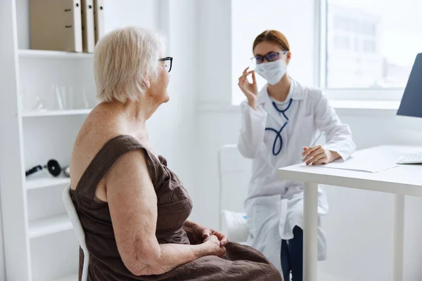 Medici nello studio medico esame del paziente assistenza sanitaria — Foto Stock