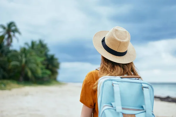 Traveler with backpack hat on head and orange sundress tourism back view — Stock Photo, Image
