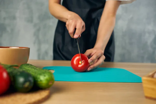 Femme au foyer sur la cuisine coupe légumes planche à découper — Photo