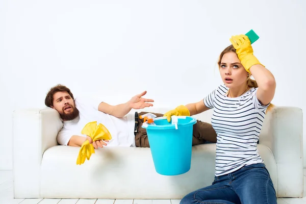 Married couple near the sofa cleaning of the apartment provision of services — Stock Photo, Image