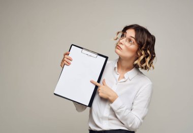 Beyaz gömlekli kadın, el işi klasöründe.