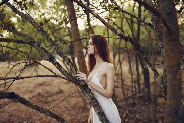 Woman in white dress on nature summer forest trees walk. High quality photo