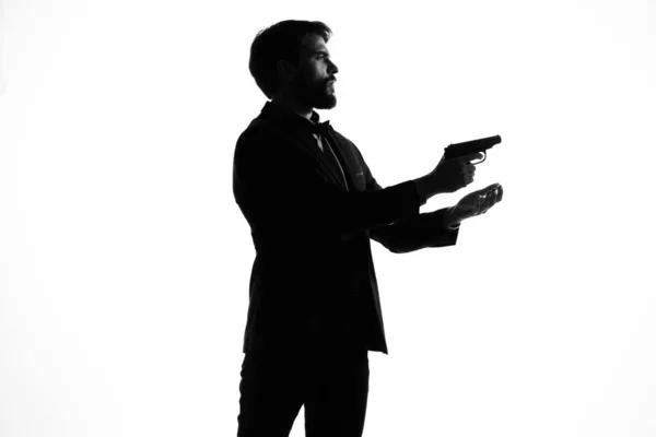 Hombre con una pistola en la mano gesto mano crimen aislado fondo —  Fotos de Stock