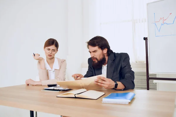 Man och kvinna sitter vid ett skrivbord kontor arbete kommunikation yrkesverksamma — Stockfoto