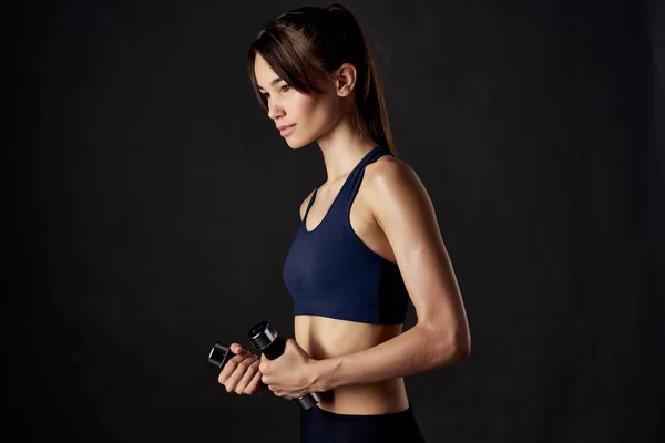 Pretty brunette with dumbbells in hands sports figure exercise fitness — Stock Photo, Image