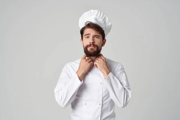 bearded man work uniform profession kitchen stuff light background