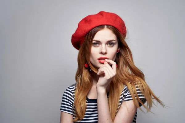 Fransız Avrupa tarzı poz veren kırmızı şapkalı neşeli bir kadın. — Stok fotoğraf
