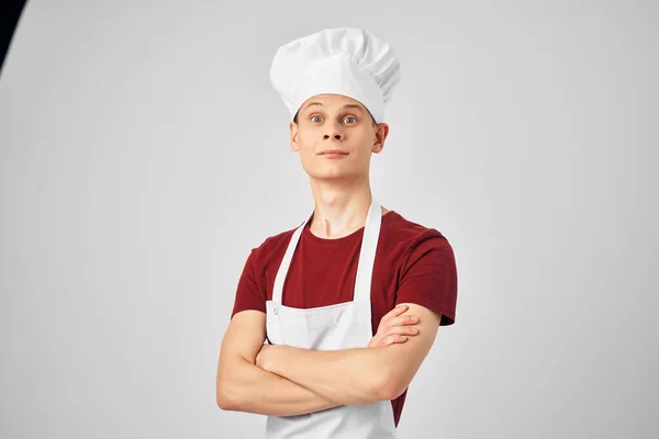 Male chef with a cap on his head kitchen professionals light background — Stock Photo, Image