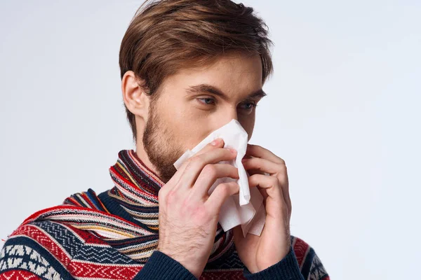 Emotional man wiping his nose with a handkerchief infection virus light background — Stock Photo, Image