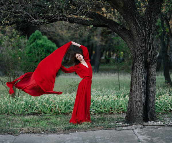 Woman in red dress nature tree lifestyle. High quality photo