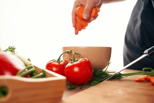 Affettare carote su un tagliere cucina cottura vegetarianismo — Foto Stock