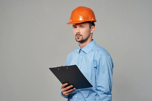 male builder in a blue shirt emotions professional studio posing