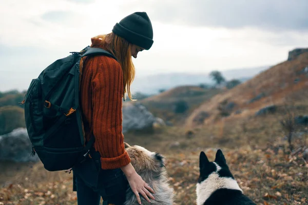 Woman travels in the mountains with a dog walk friendship autumn — Stock Photo, Image