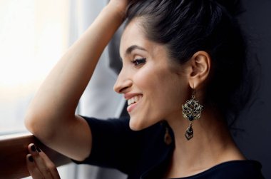 Güzel bir kadın cam dekorasyonunun yanında fotoğraf makinesi tutuyor. Zarif bir tarz.