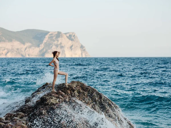 Pretty woman in white bikini beach posing rocks summer — Stock Photo, Image