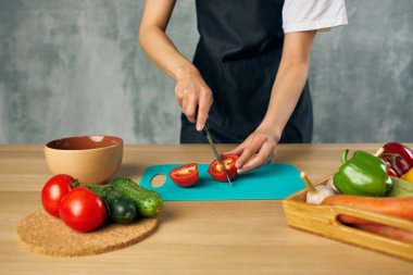 Siyah önlüklü aşçı sağlıklı yemek yapıyor salata diyeti yapıyor.